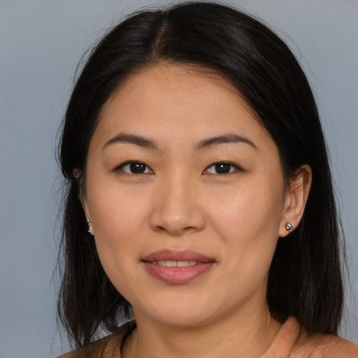 Joyful asian young-adult female with medium  brown hair and brown eyes