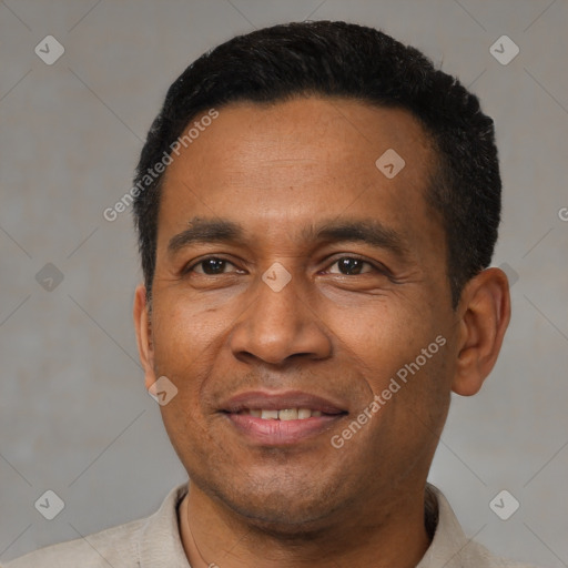 Joyful latino adult male with short  black hair and brown eyes