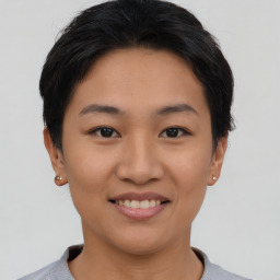 Joyful asian young-adult female with short  brown hair and brown eyes