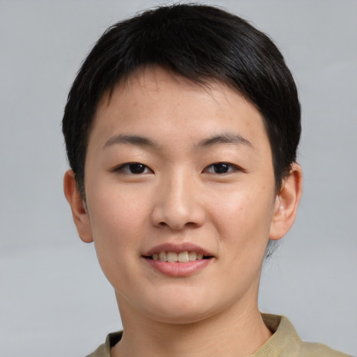 Joyful asian young-adult female with short  brown hair and brown eyes
