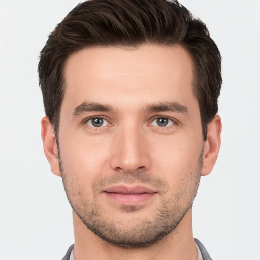 Joyful white young-adult male with short  brown hair and brown eyes