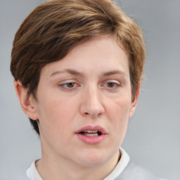 Joyful white adult female with short  brown hair and grey eyes