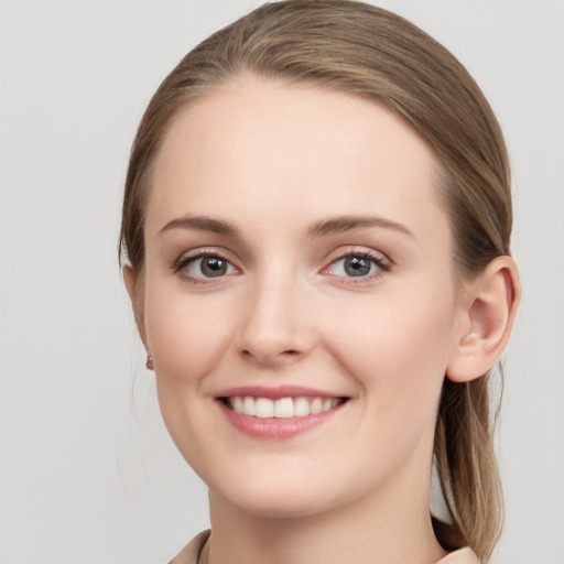 Joyful white young-adult female with long  brown hair and grey eyes