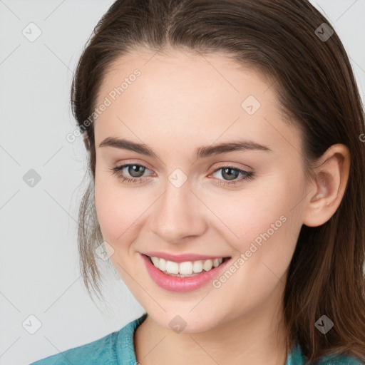 Joyful white young-adult female with medium  brown hair and grey eyes