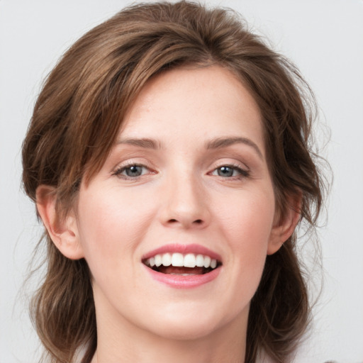 Joyful white young-adult female with medium  brown hair and blue eyes