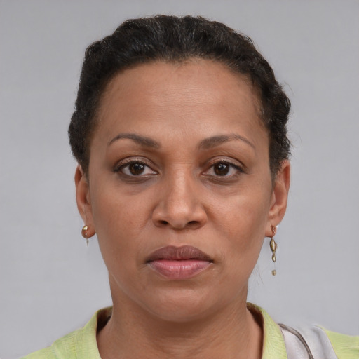 Joyful latino adult female with short  brown hair and brown eyes