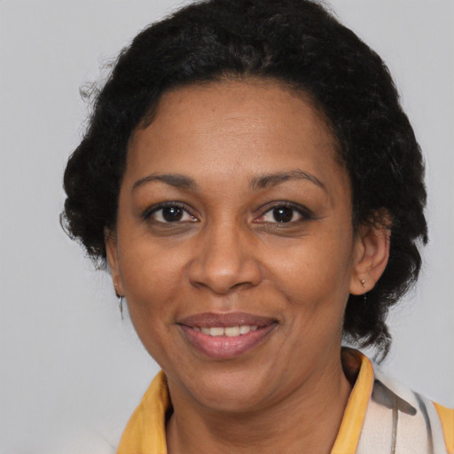 Joyful black adult female with short  brown hair and brown eyes