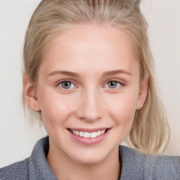 Joyful white young-adult female with medium  brown hair and blue eyes