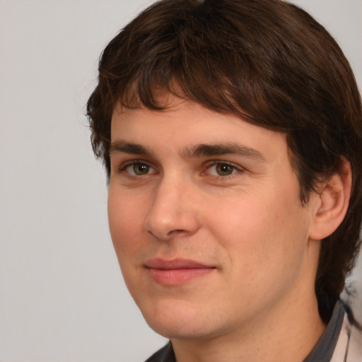 Joyful white young-adult male with medium  brown hair and brown eyes