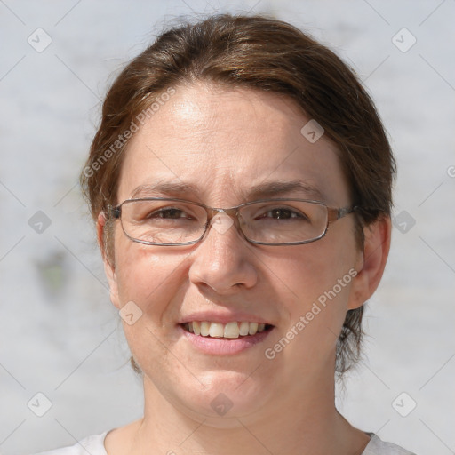 Joyful white adult female with medium  brown hair and grey eyes