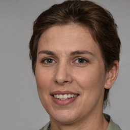 Joyful white adult female with medium  brown hair and brown eyes