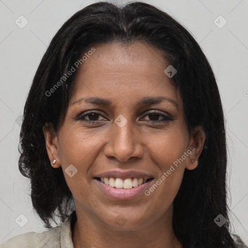 Joyful black young-adult female with long  brown hair and brown eyes