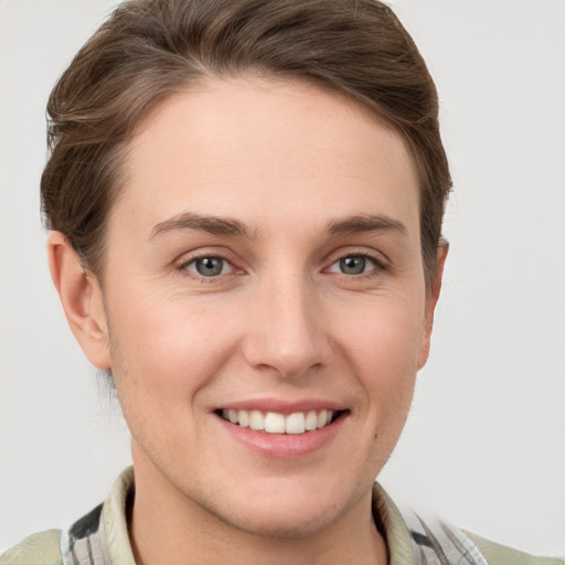 Joyful white young-adult female with short  brown hair and grey eyes