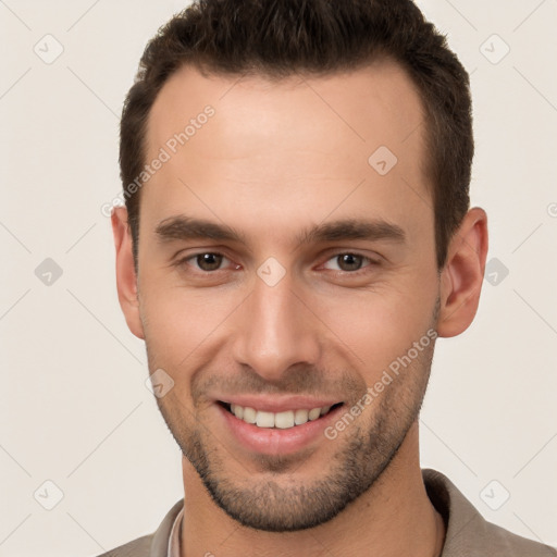 Joyful white young-adult male with short  brown hair and brown eyes