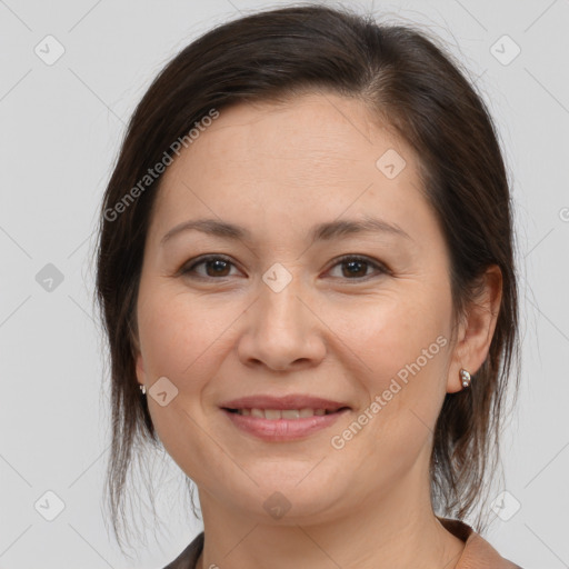 Joyful white adult female with medium  brown hair and brown eyes