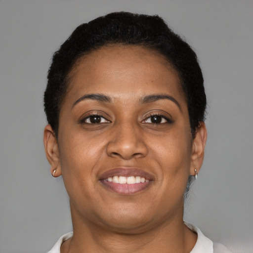 Joyful black young-adult female with short  brown hair and brown eyes