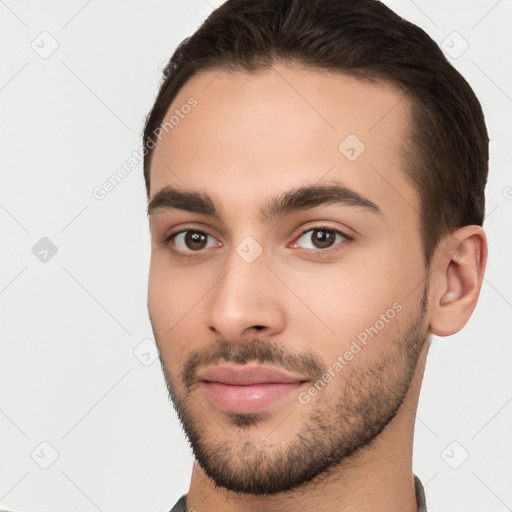 Joyful white young-adult male with short  brown hair and brown eyes