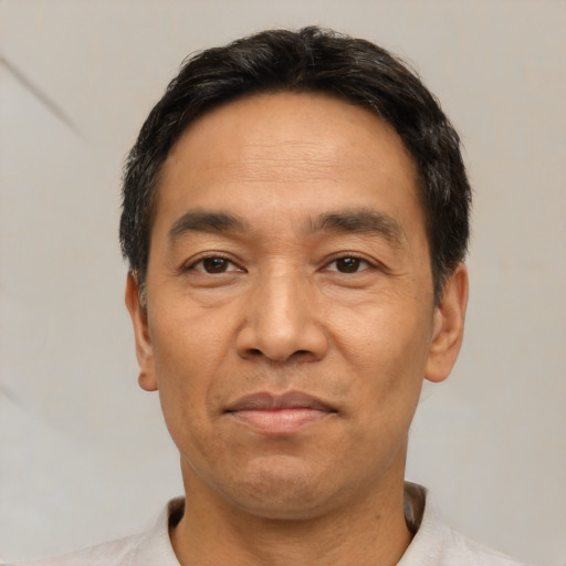 Joyful white adult male with short  black hair and brown eyes