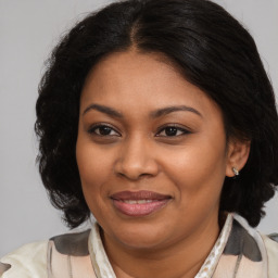 Joyful black young-adult female with medium  brown hair and brown eyes