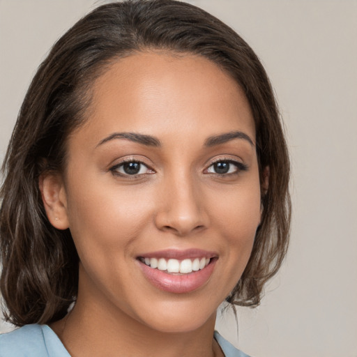 Joyful white young-adult female with medium  brown hair and brown eyes