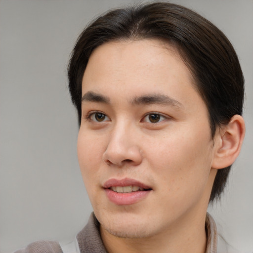 Joyful asian young-adult male with medium  brown hair and brown eyes
