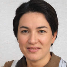 Joyful white adult female with medium  brown hair and brown eyes