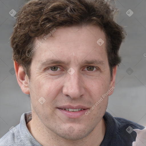 Joyful white adult male with short  brown hair and grey eyes