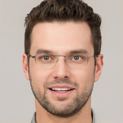 Joyful white young-adult male with short  brown hair and grey eyes