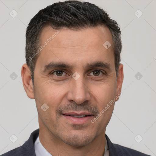 Joyful white adult male with short  brown hair and brown eyes