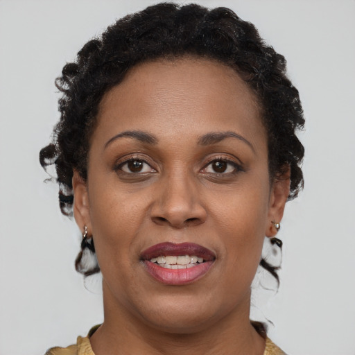 Joyful black adult female with short  brown hair and brown eyes