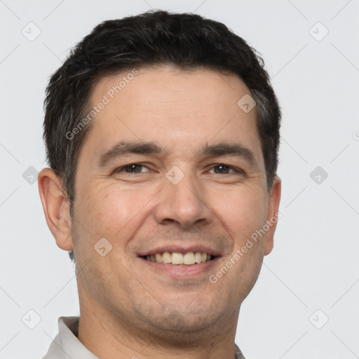 Joyful white adult male with short  brown hair and brown eyes