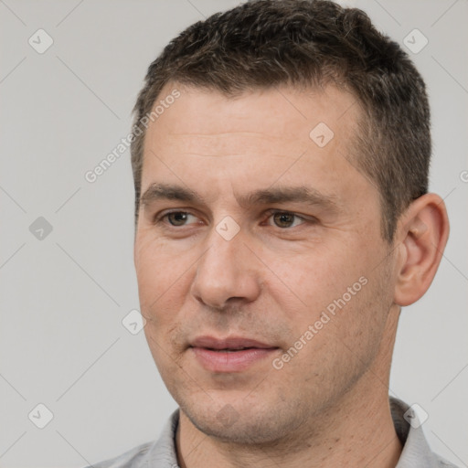 Joyful white adult male with short  brown hair and brown eyes