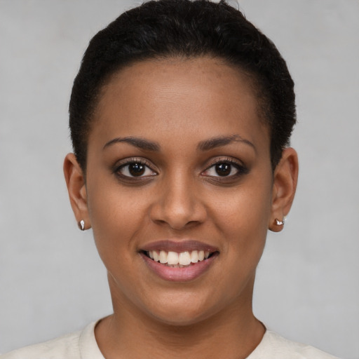 Joyful latino young-adult female with short  brown hair and brown eyes