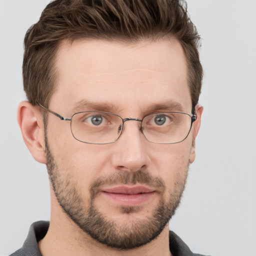 Joyful white adult male with short  brown hair and grey eyes