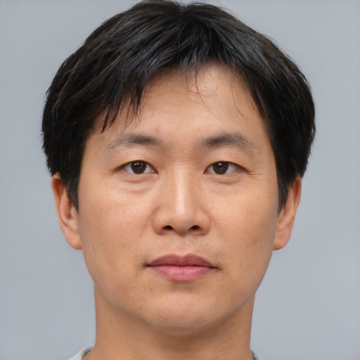 Neutral asian adult male with short  brown hair and brown eyes