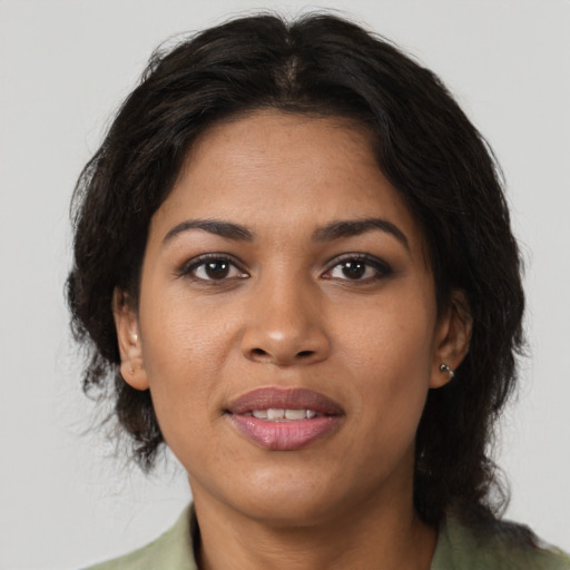 Joyful black young-adult female with medium  brown hair and brown eyes