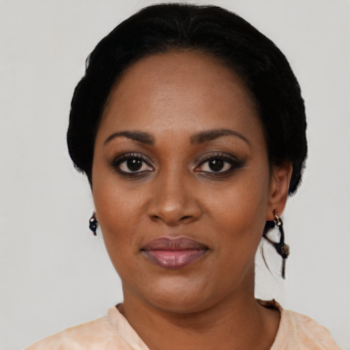 Joyful black adult female with short  black hair and brown eyes