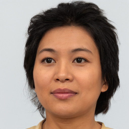 Joyful asian adult female with medium  brown hair and brown eyes