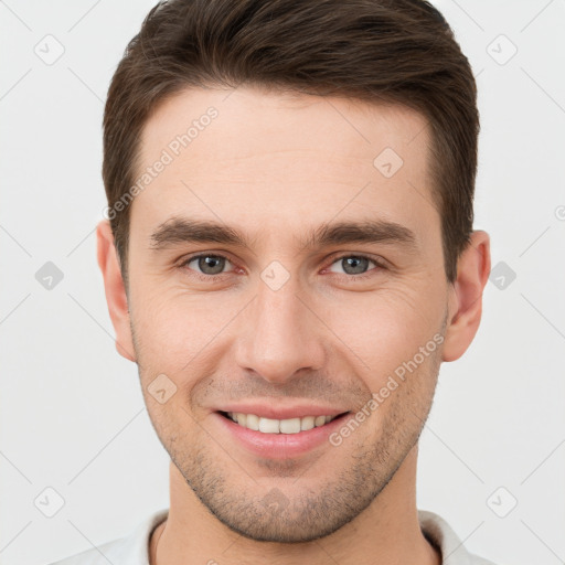 Joyful white young-adult male with short  brown hair and brown eyes