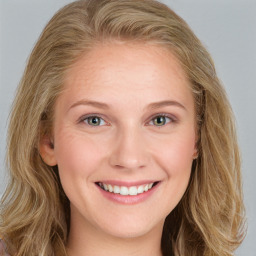 Joyful white young-adult female with long  brown hair and blue eyes