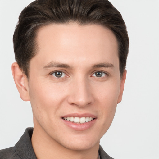 Joyful white young-adult male with short  brown hair and brown eyes