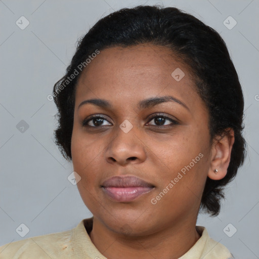 Joyful black young-adult female with short  black hair and brown eyes