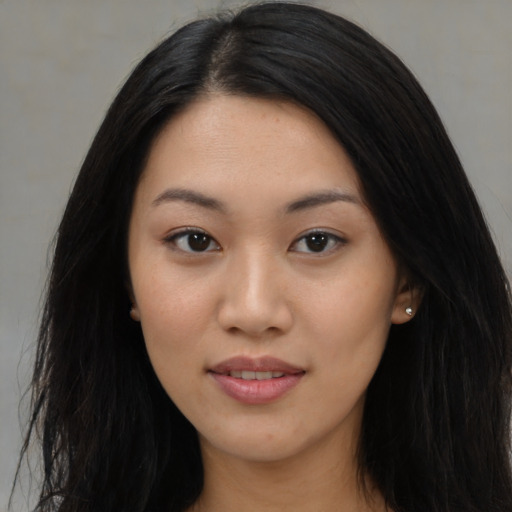 Joyful asian young-adult female with long  black hair and brown eyes