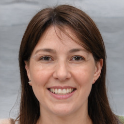 Joyful white adult female with long  brown hair and brown eyes