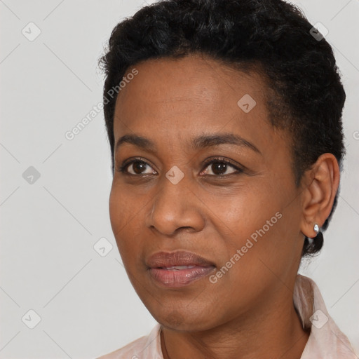 Joyful black adult female with short  black hair and brown eyes