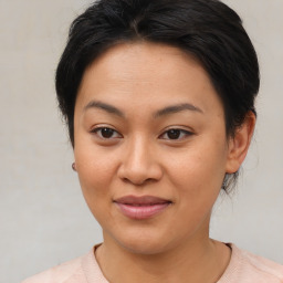 Joyful asian young-adult female with medium  brown hair and brown eyes