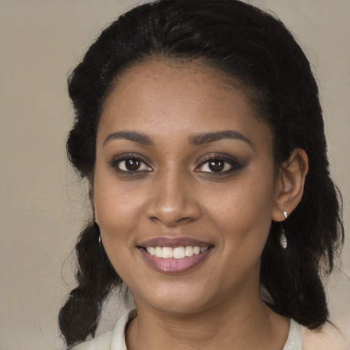 Joyful black young-adult female with medium  black hair and brown eyes