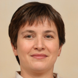 Joyful white adult female with short  brown hair and brown eyes