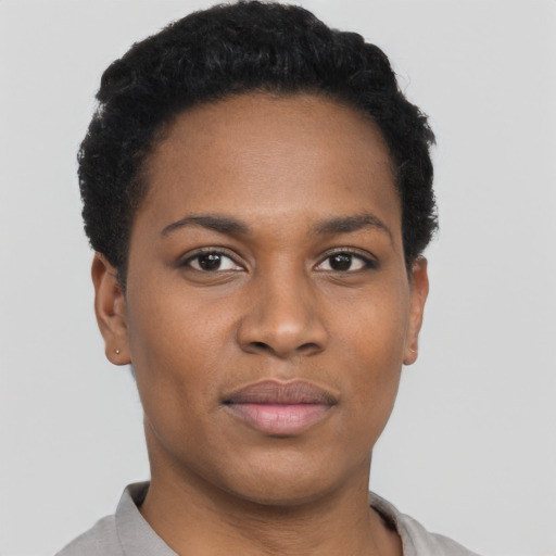 Joyful black young-adult female with short  black hair and brown eyes
