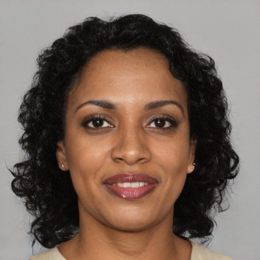 Joyful black young-adult female with medium  black hair and brown eyes
